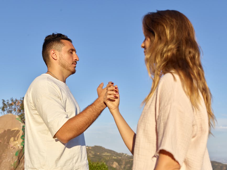 A man and woman holding hands in a serene outdoor setting, symbolizing connection and mindfulness.