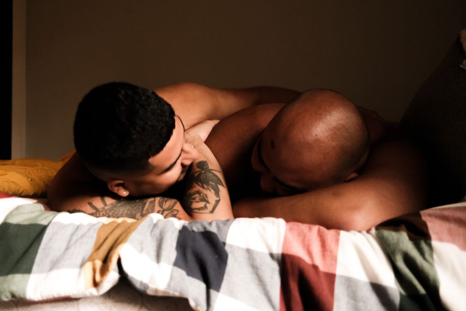 A close and peaceful moment shared between two individuals lying on a bed, expressing warmth and connection.